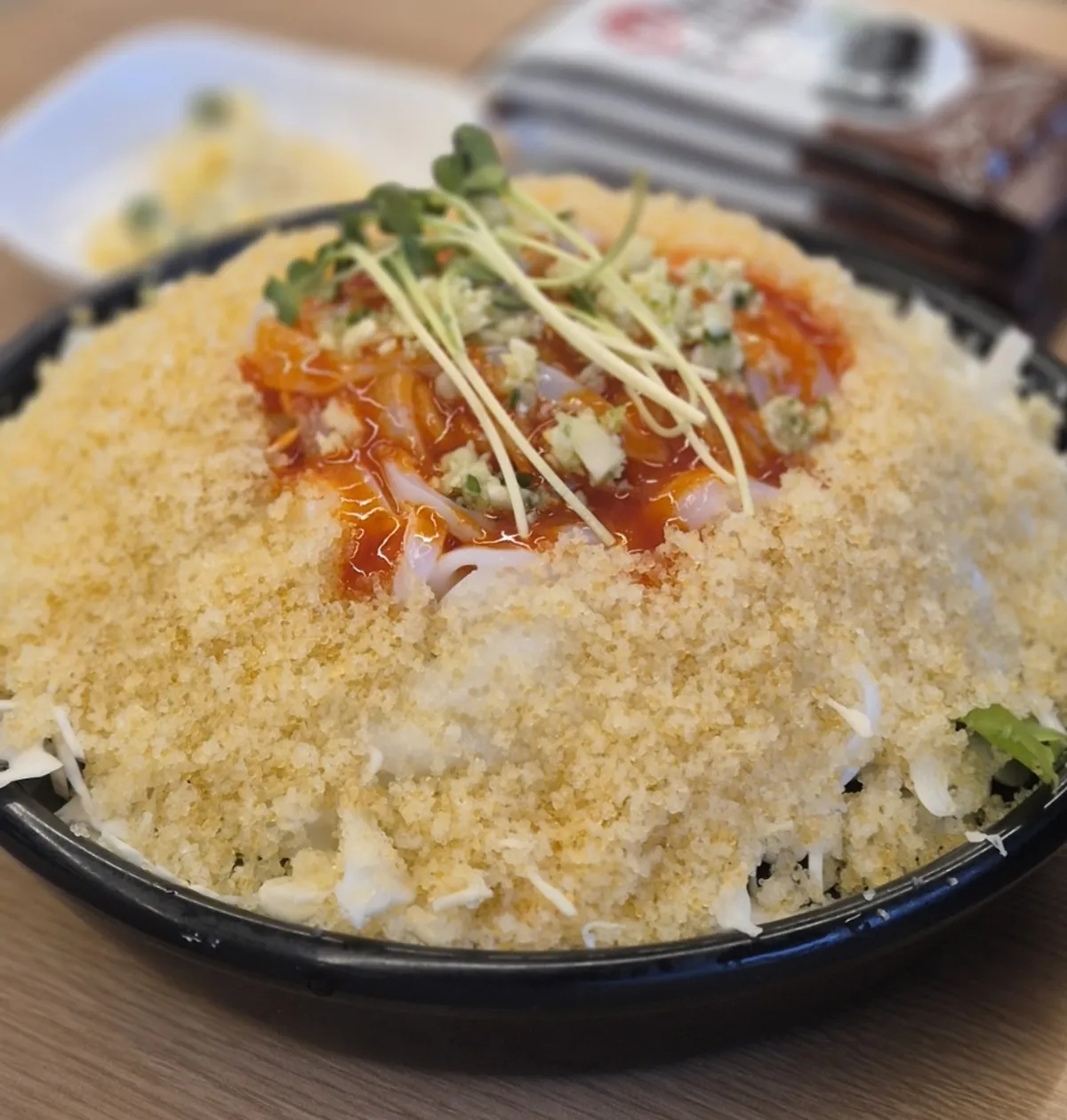 A tall-piled plate of flying fish roe cuttlefish sashimi