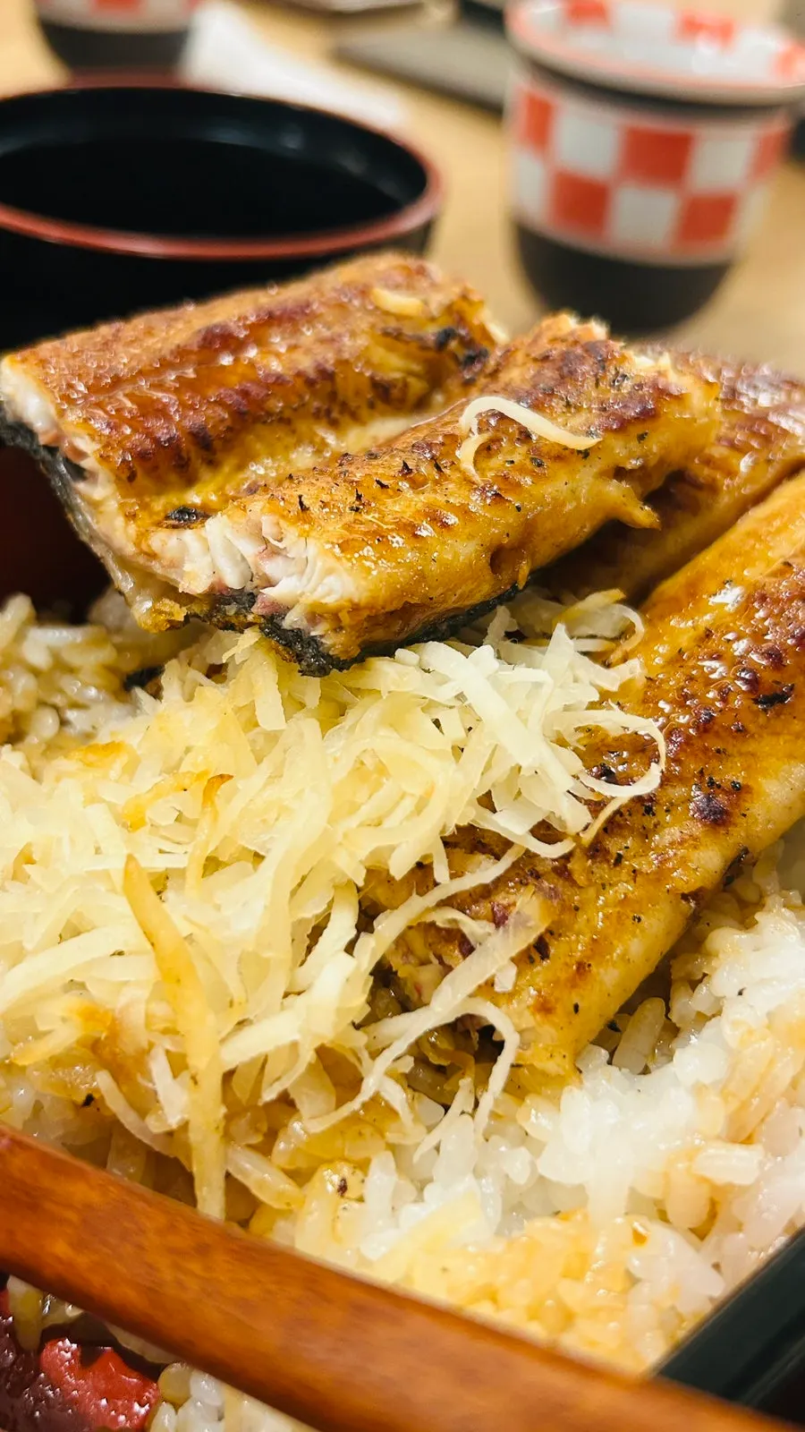 A spoonful taken from Unagiwa's eel rice bowl