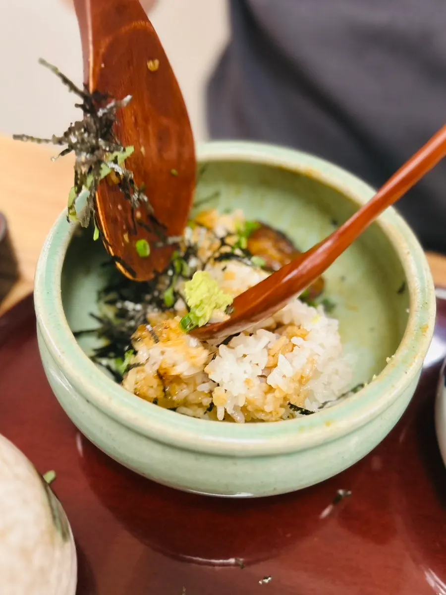 Hitsumabushi divided into four portions with a rice paddle