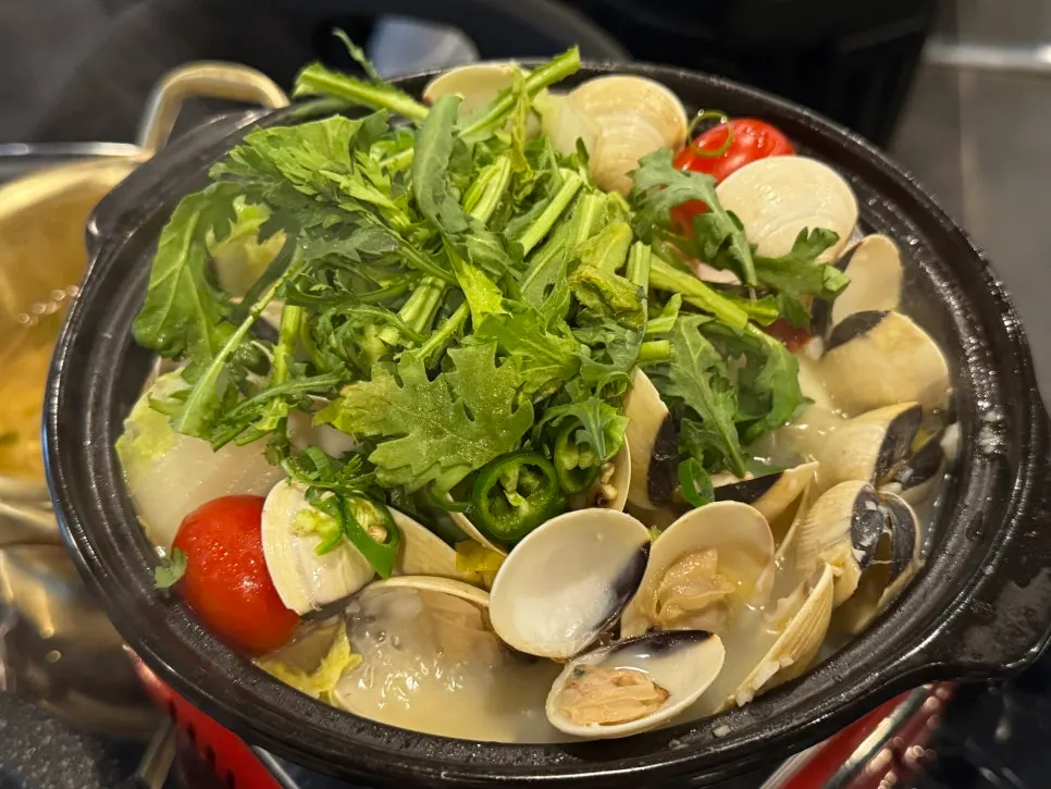 Clam wine stew broth loaded with napa cabbage