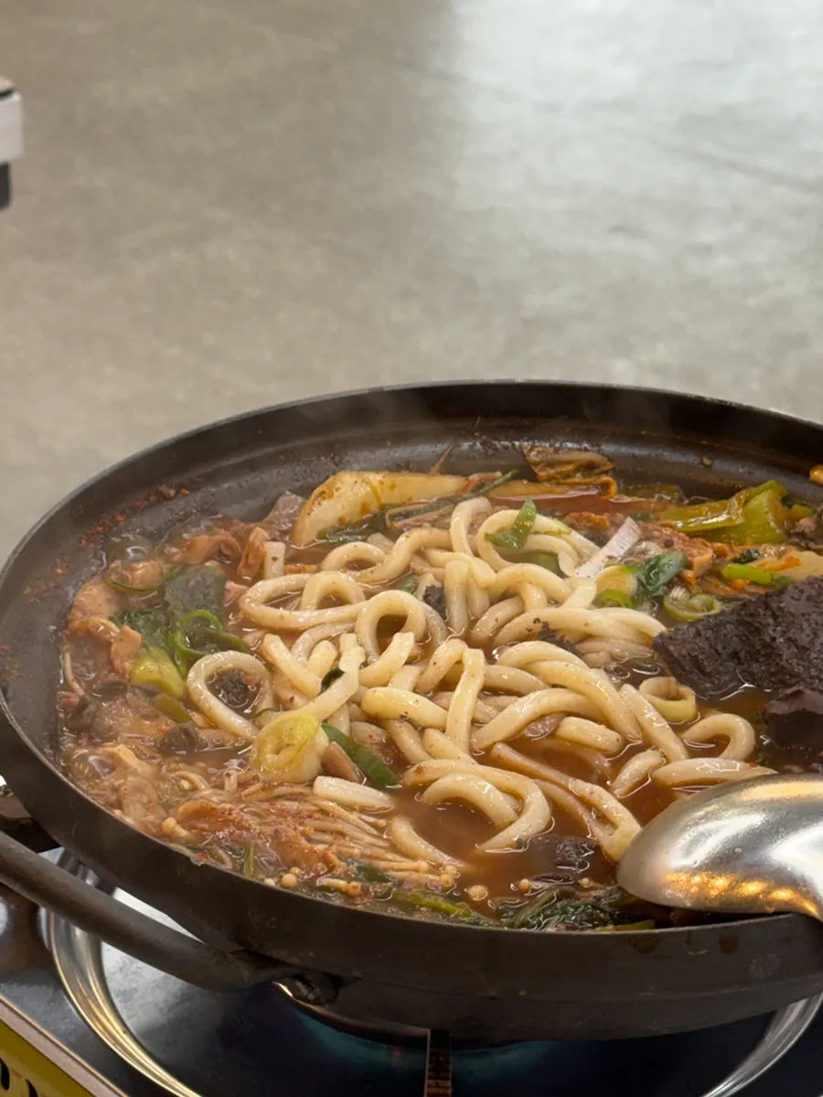 Springy udon noodles cooked in the hot pot broth