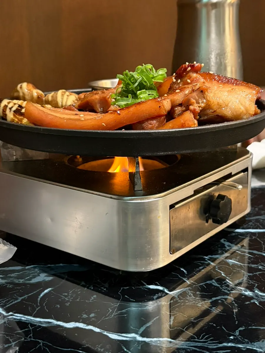 Seasoned BBQ placed on the mini brazier