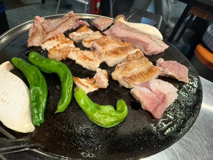 Meat and vegetables browning on the grill