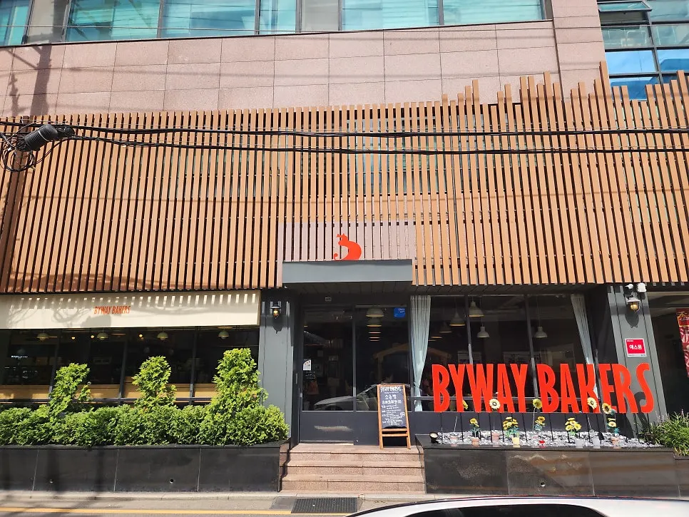 우드 루버와 오렌지 로고의 베이커리 외관