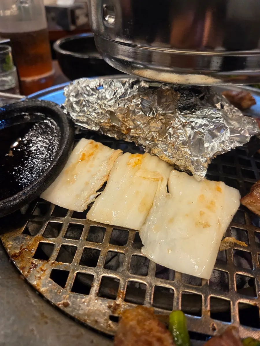 Meat dipped in Jeju-style anchovy stew