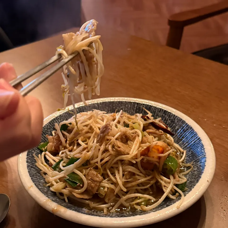 A plate of pork and bean sprout stir-fry ready to share