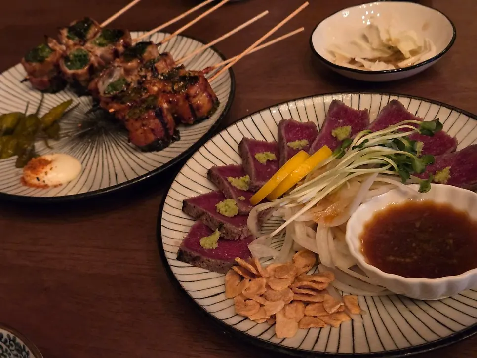 Plate of beef intestine and pork belly scallion skewers