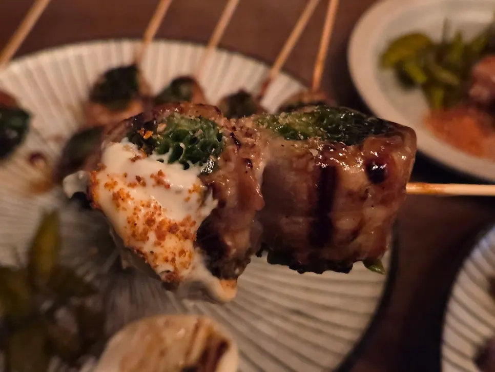 Picking up the pork belly scallion skewer