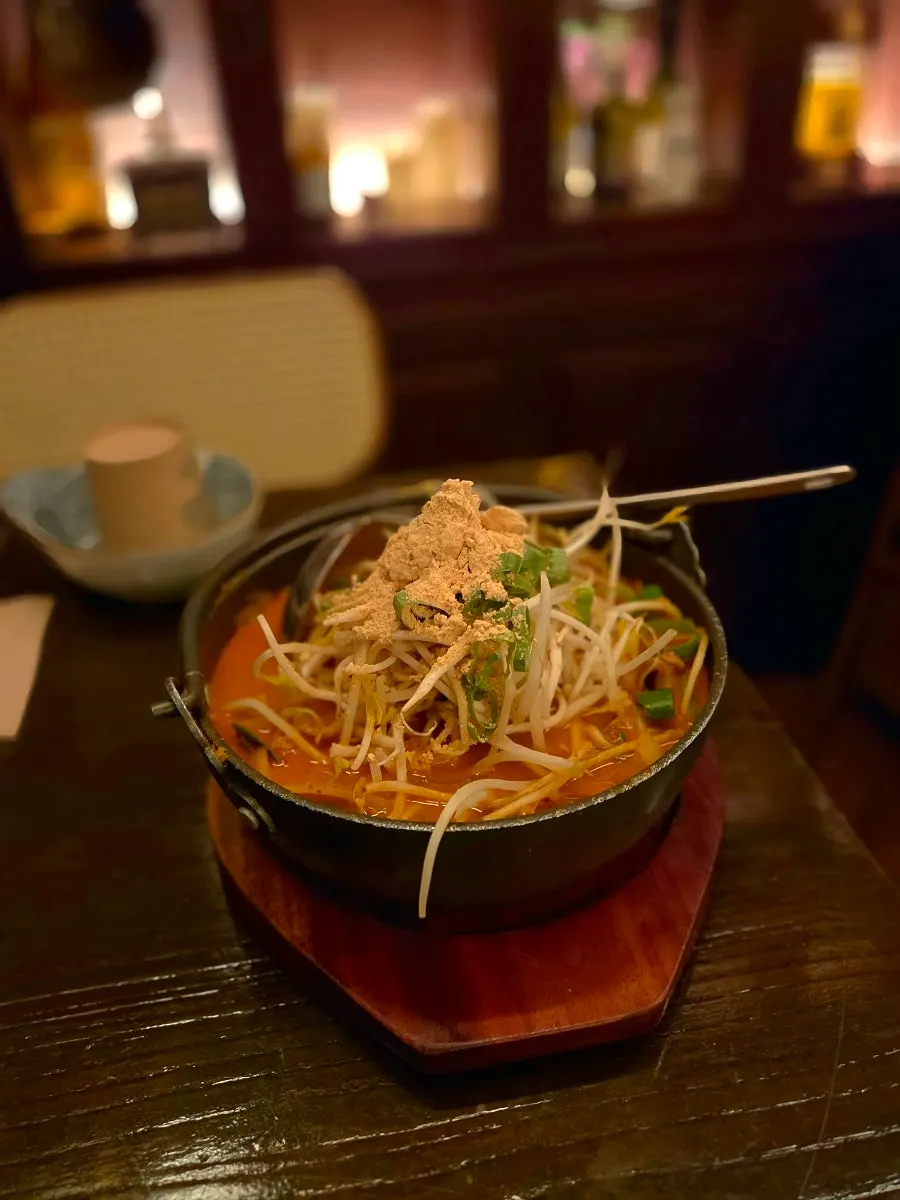 Beef brisket nabe topped with bean sprouts and brisket