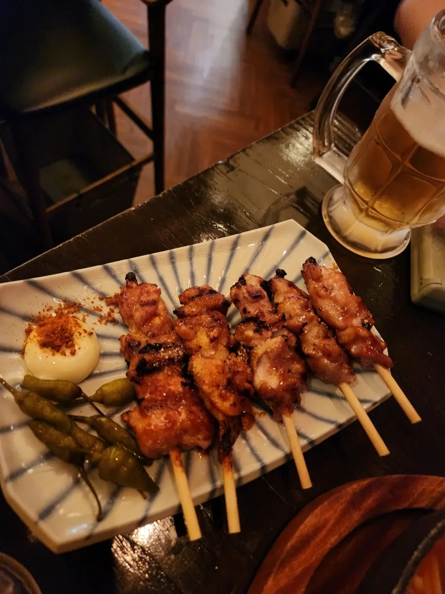A glass of draft beer with side dishes on the table