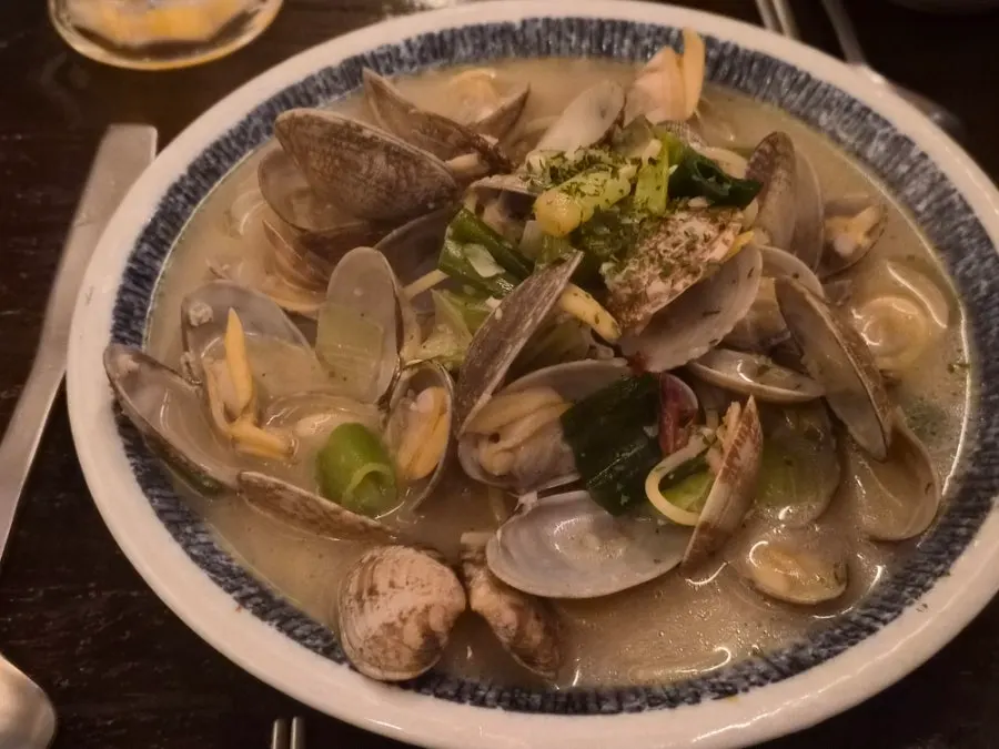 A bowl of clam sake stew served with broth