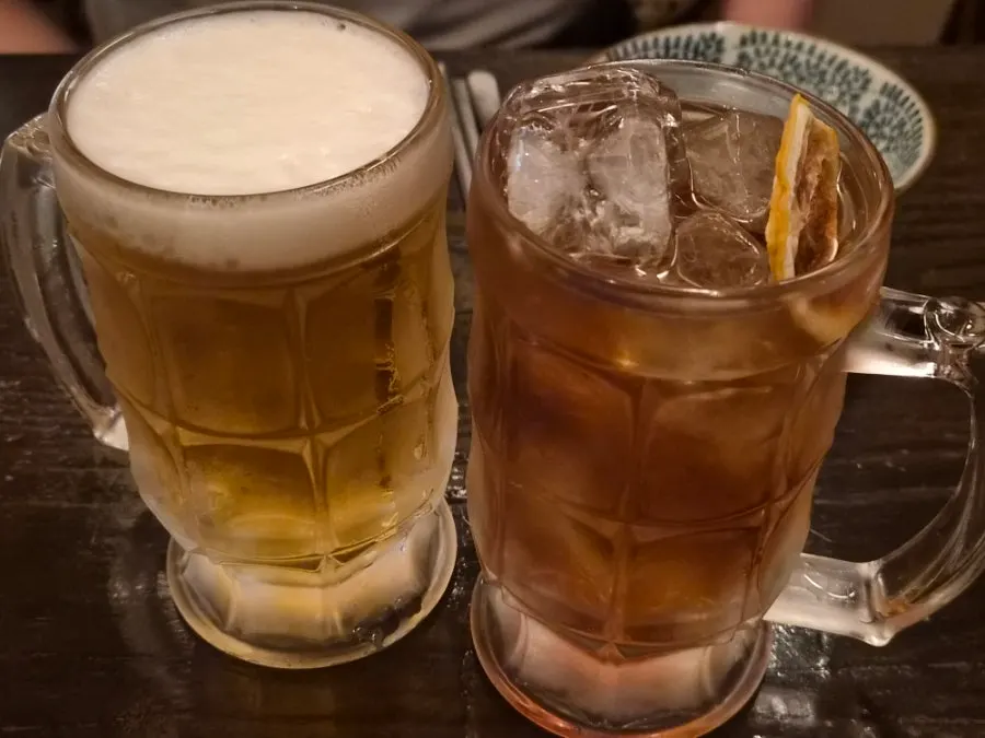 Table with two highballs and food set out