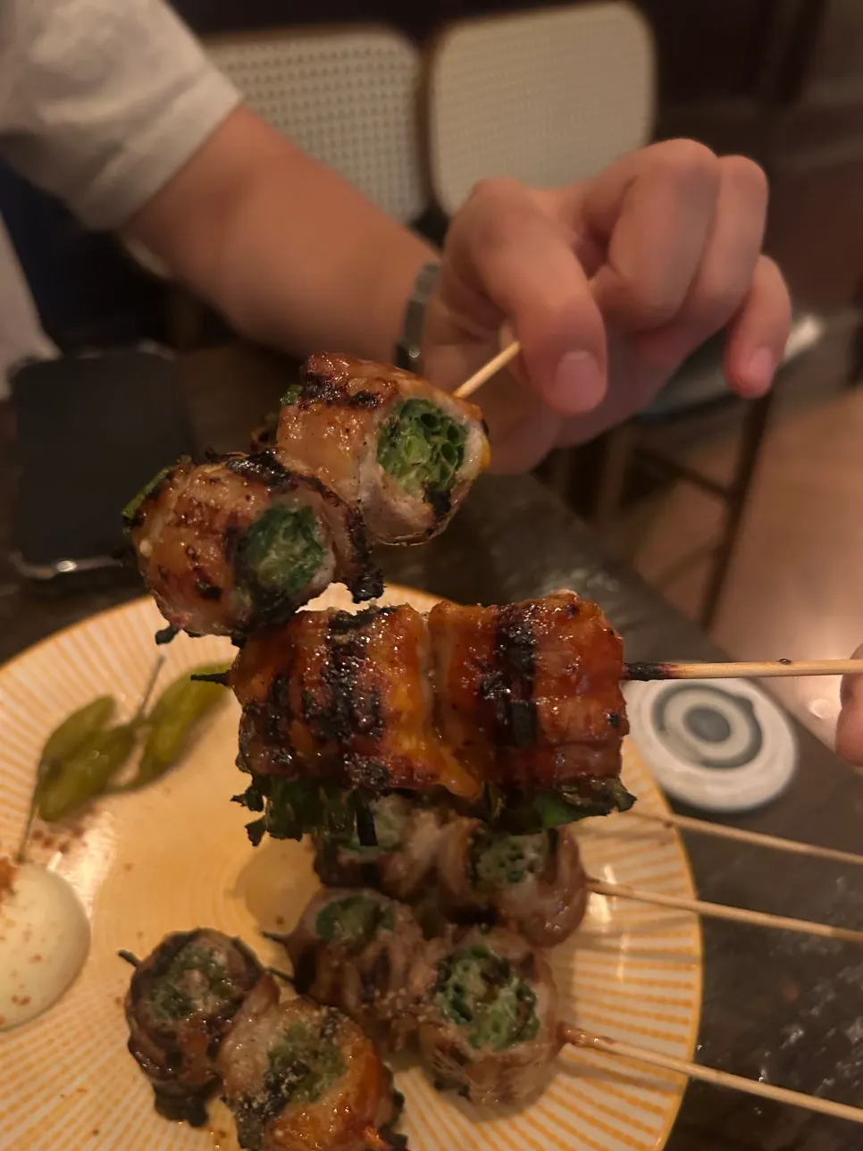 Drinking table with pork belly scallion skewers and nabe