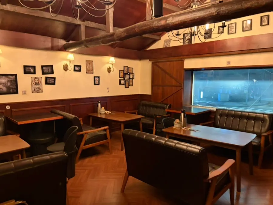 Dimly lit table seating further inside