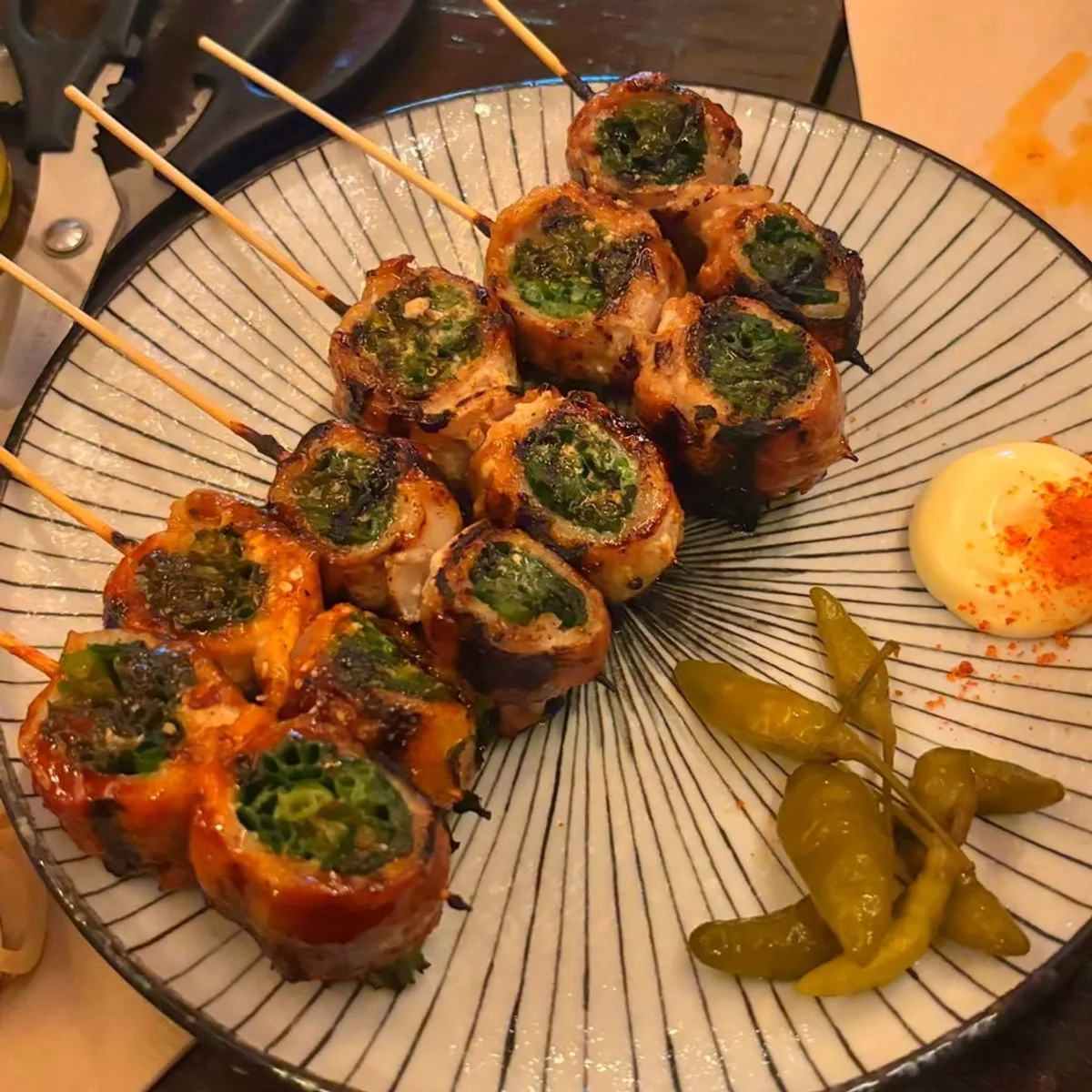 Close-up of smoky pork belly scallion skewers
