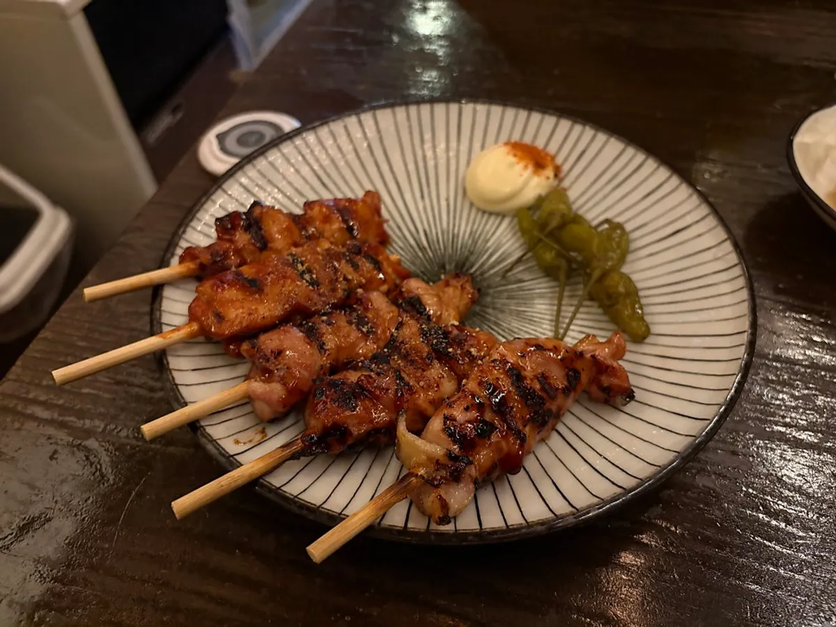 A plate of charred Nani Byeolgwan chicken skewers