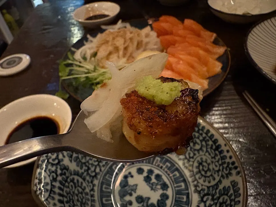 Onion drizzled with sesame dressing paired with salmon