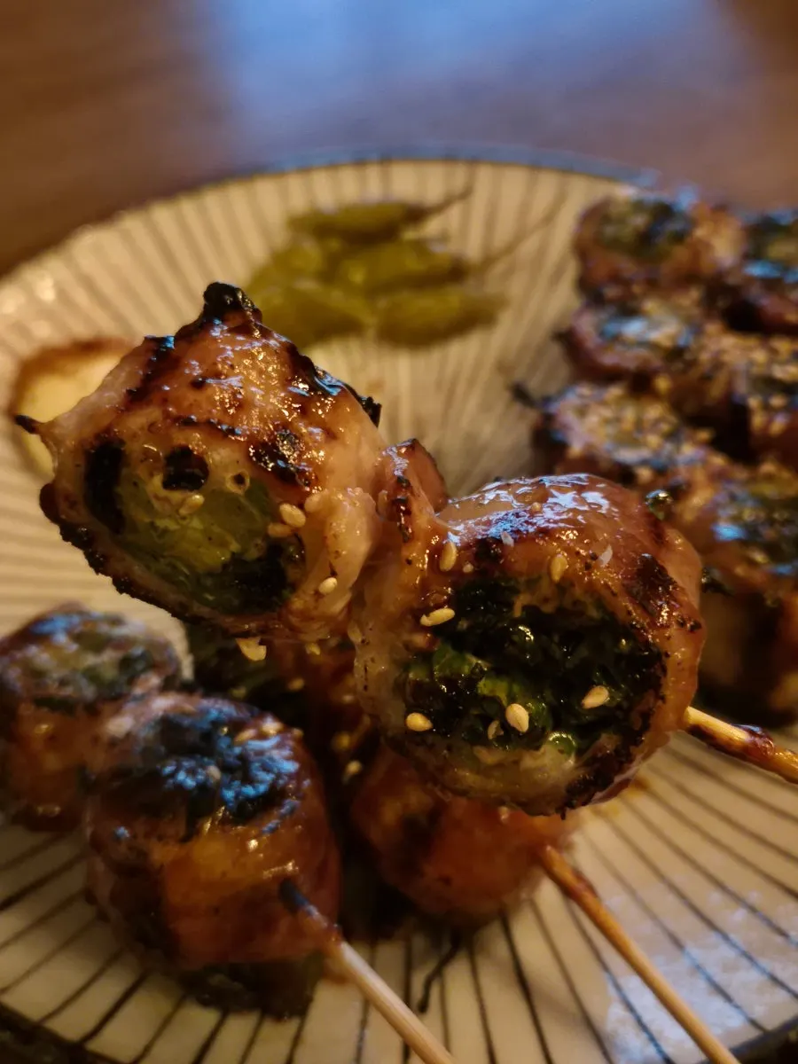 Close-up of pork belly scallion skewers