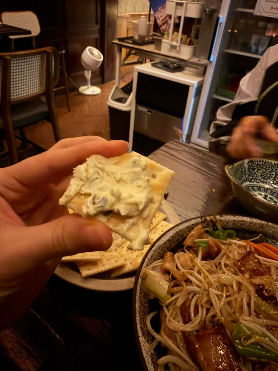 A cracker topped with cream cheese