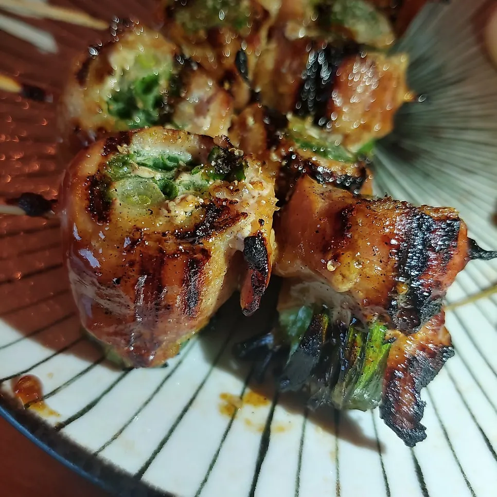 Close-up of scallion-studded pork belly skewers