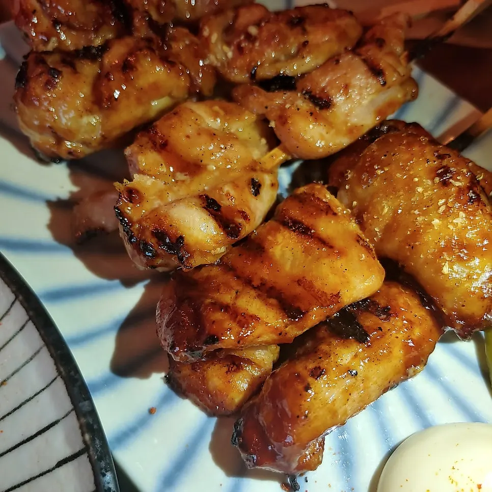 Close-up of golden-grilled chicken skewers