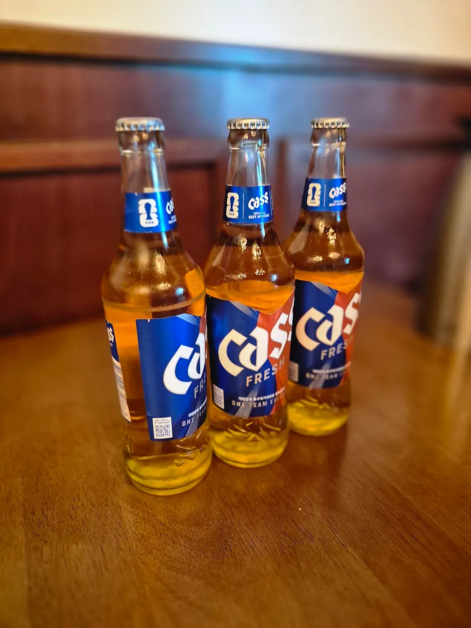 Vertical shot of Cass beer with skewers
