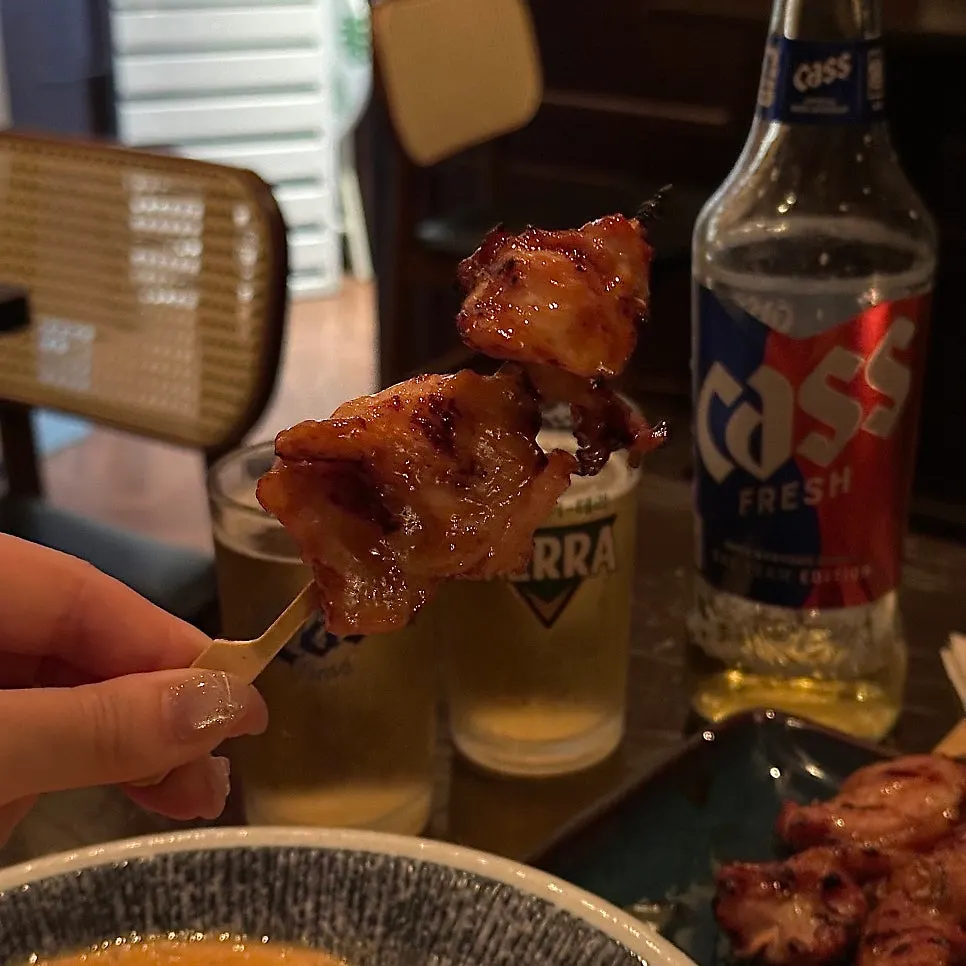 A chicken skewer picked up from the plate