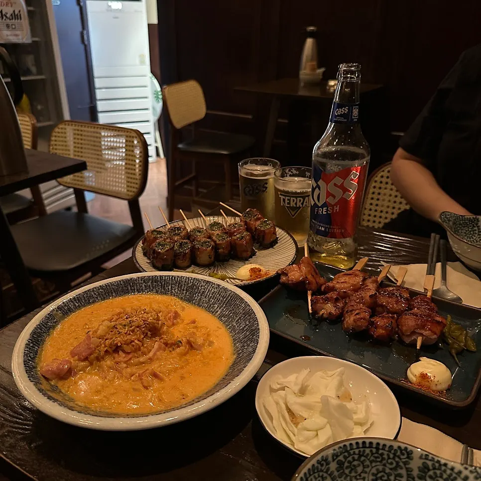Table full of skewers and risotto