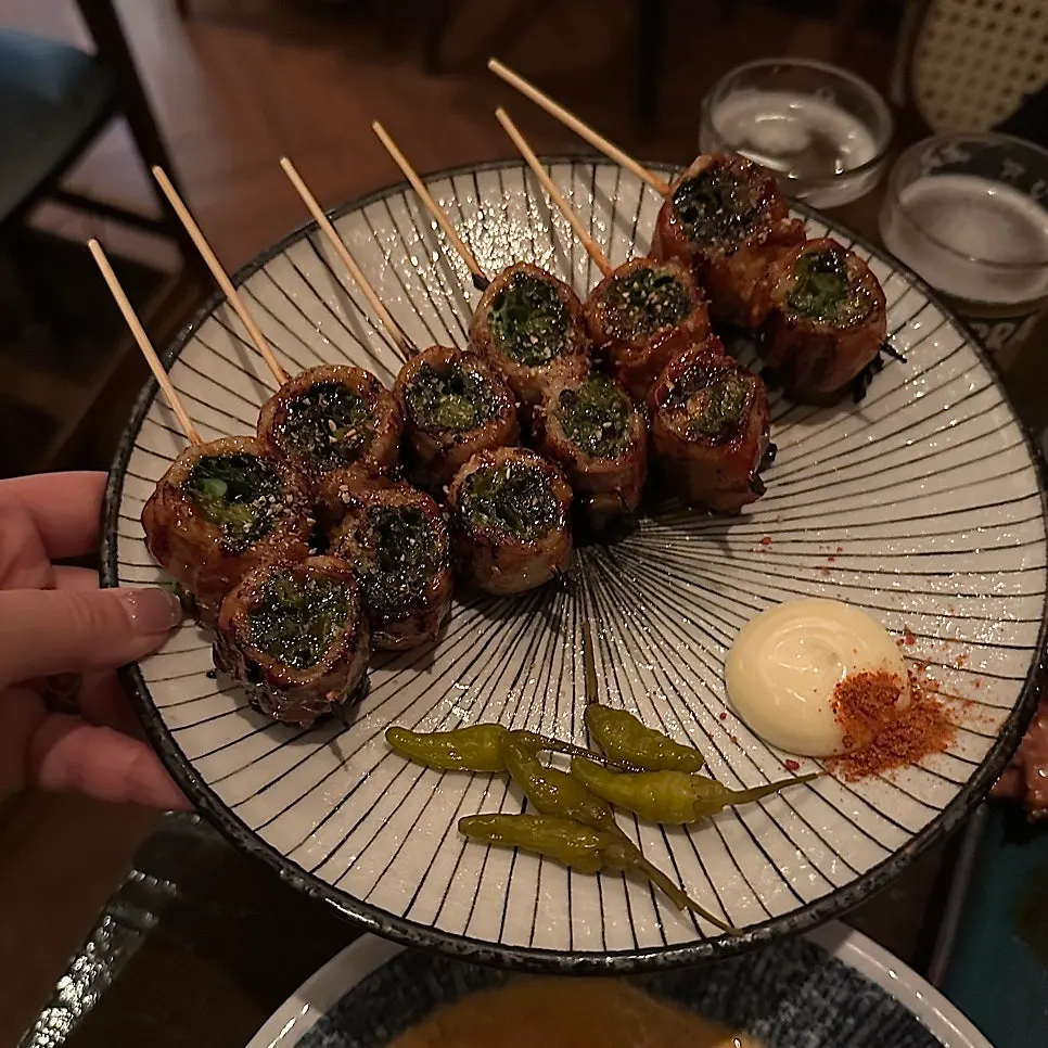Pork belly skewers wrapped with scallion, close-up