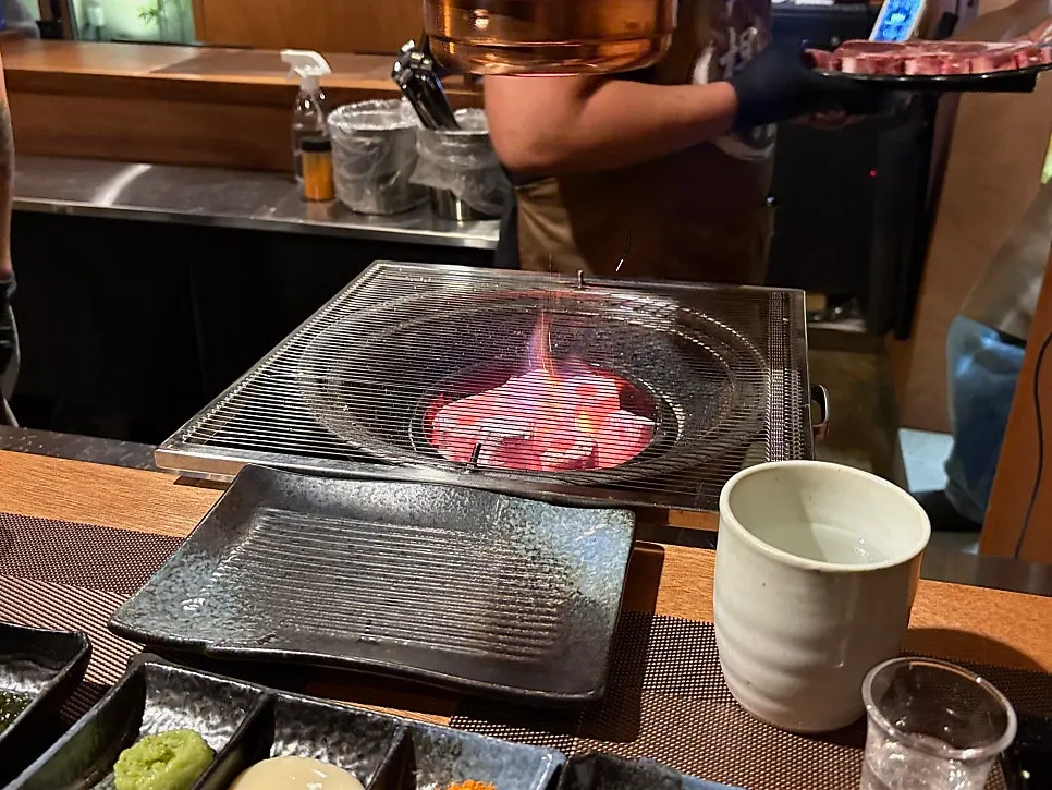 Charcoal grill seat right in front of the bar table