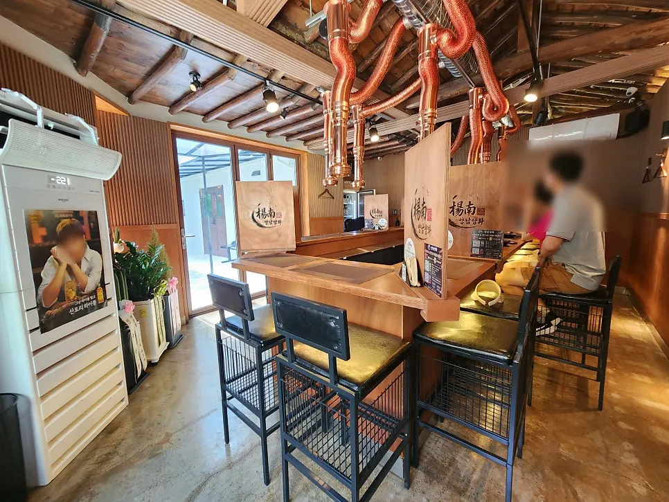Bar-table seating beneath exposed rafters