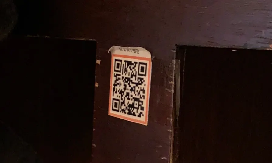 QR code menu guide posted on the wall