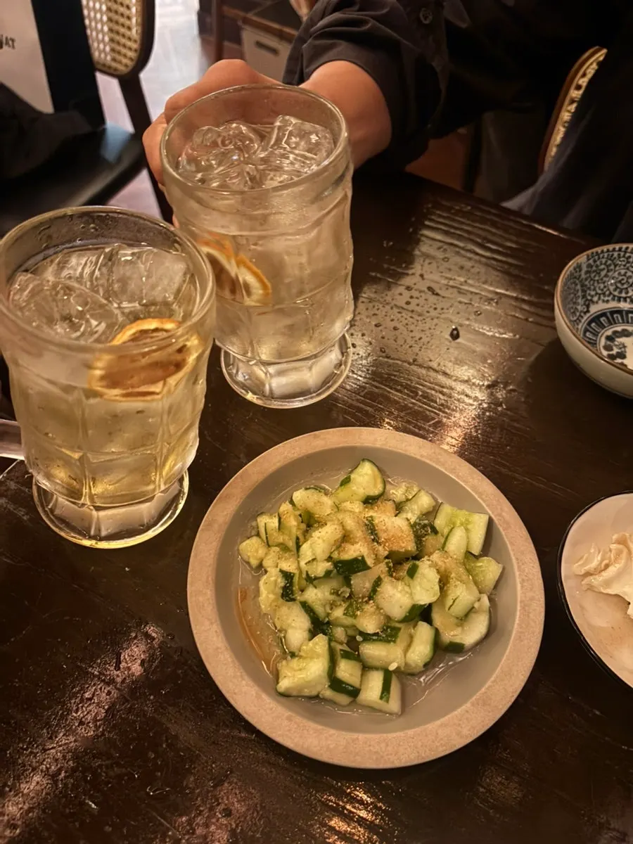 Table set with mojito highball and cucumber salad