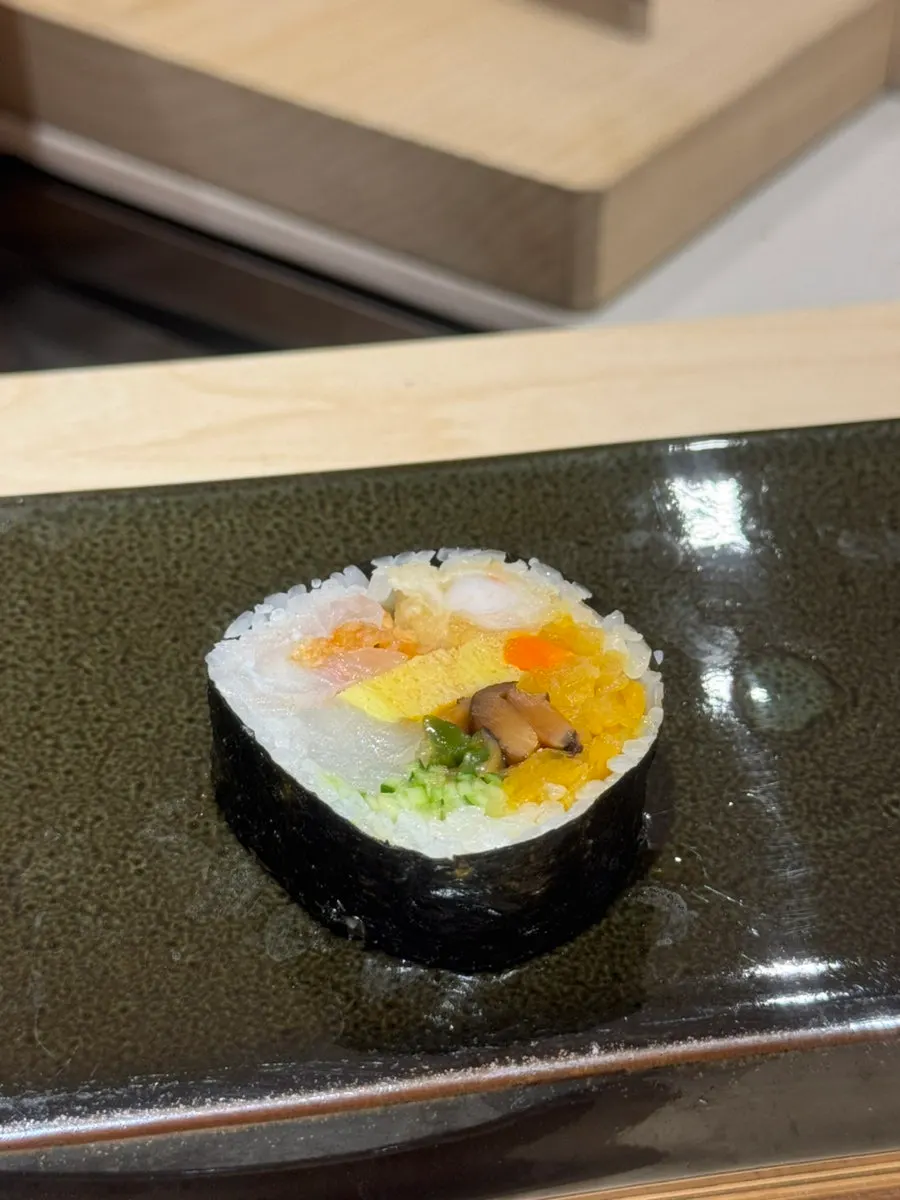 A piece of futomaki packed with various ingredients
