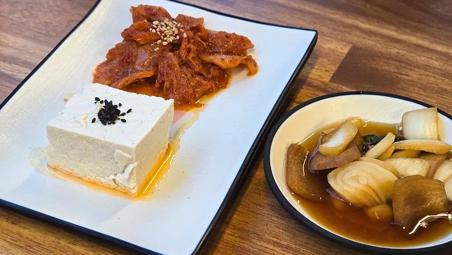 Complimentary pickled onions and tofu kimchi