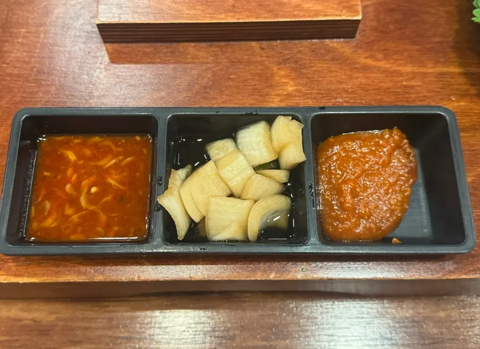 Side dishes including ssamjang, salted shrimp, and pickled onion