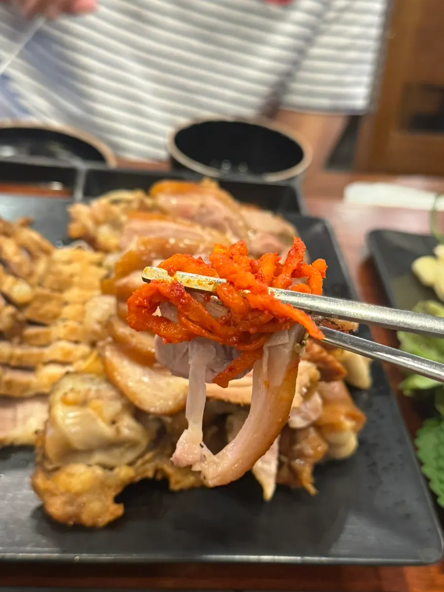 A piece of jokbal served with kimchi