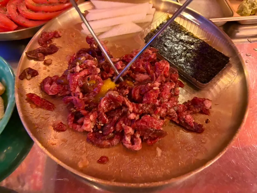 Tomato side dish next to a soju glass