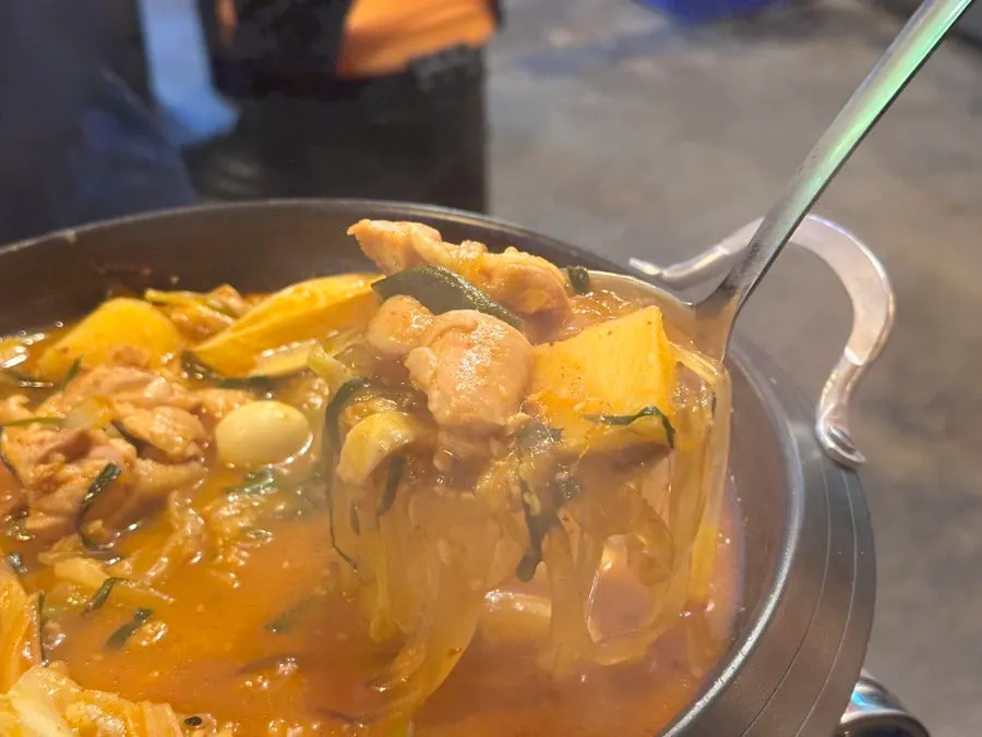 Boneless dakdoritang topped with rice cake, glass noodles, and potato
