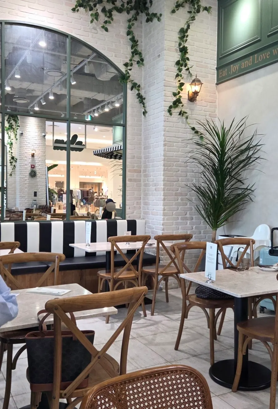 Deep green-toned seating inside Mela Times Square