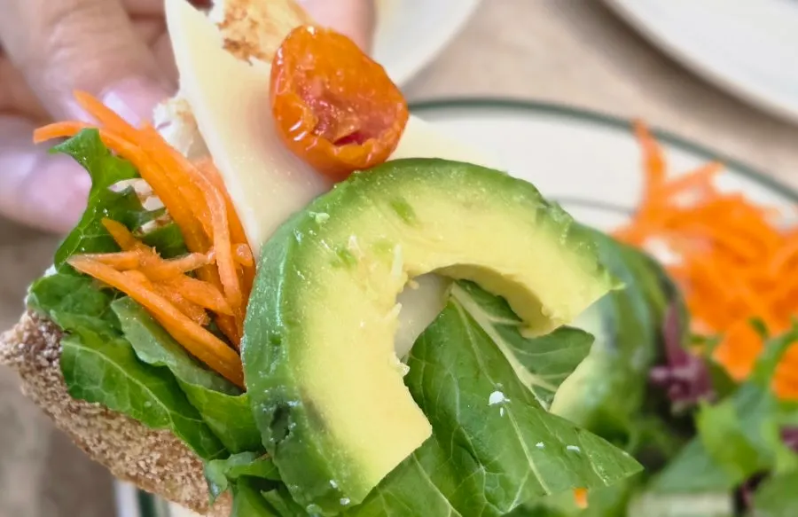 Open sandwich made with sourdough topped with cheese and salad