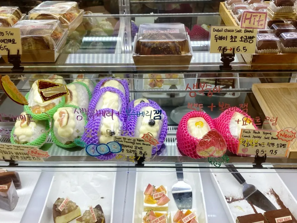 Bread display with chocolate baguettes, bagels, and more