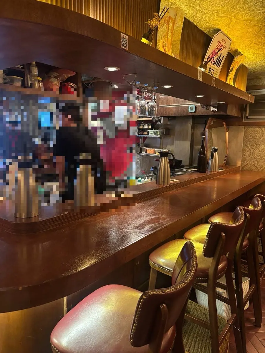 Wood-tone izakaya seating under soft lighting