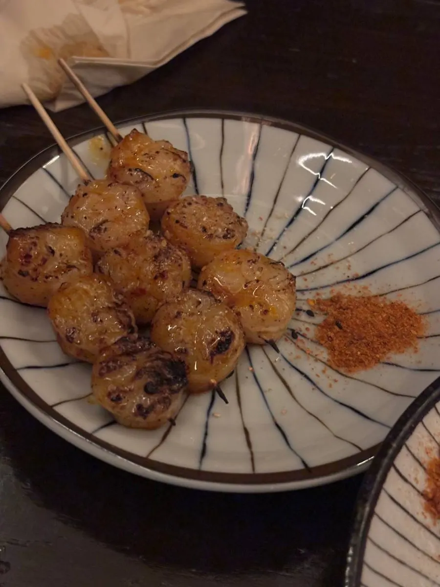 Chicken skewer dipped in sauce