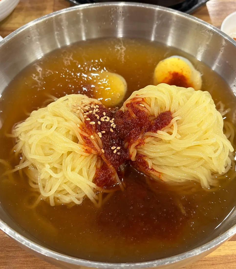 Large mul milmyeon served in a stainless steel bowl