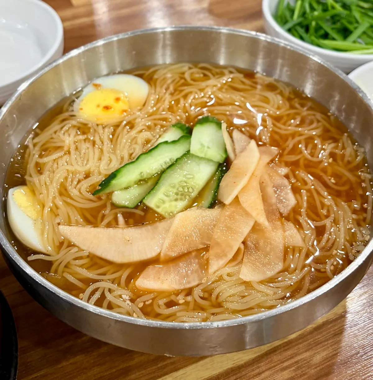Thin milmyeon noodles lifted with chopsticks