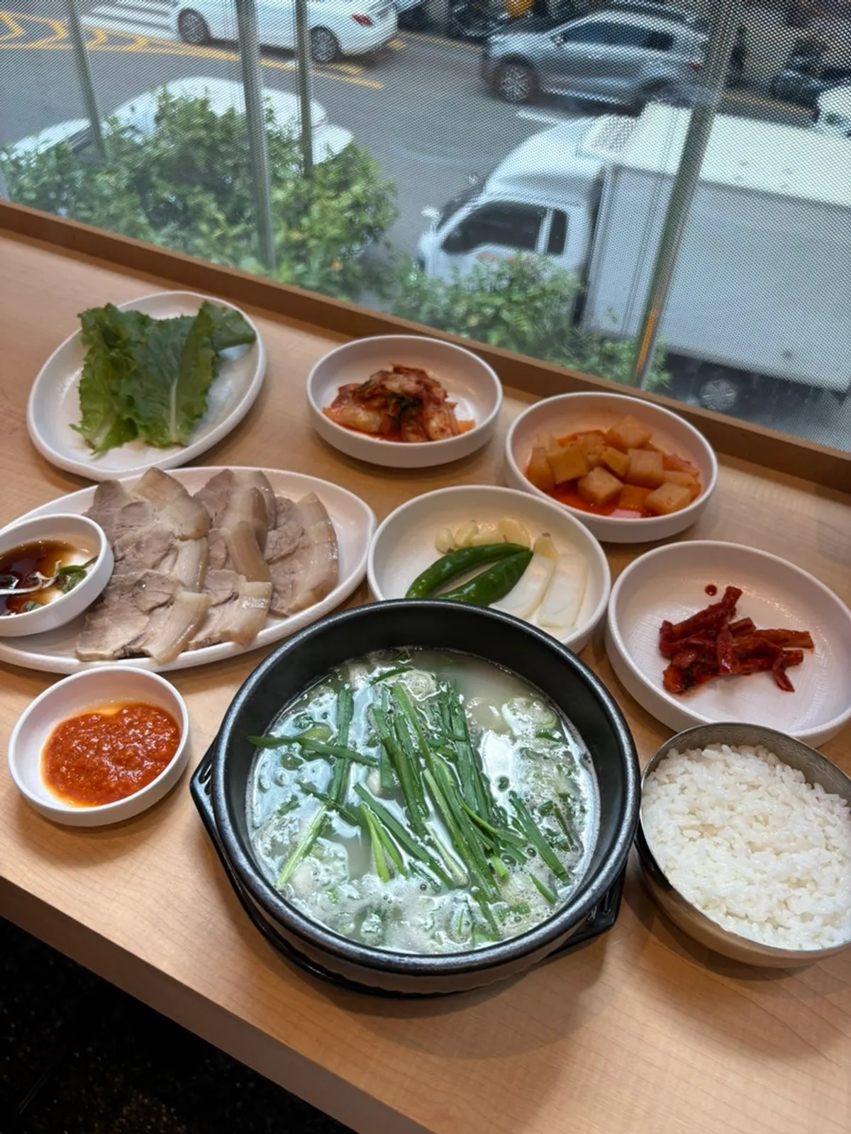 Milky suyuk baekban broth loaded with chives