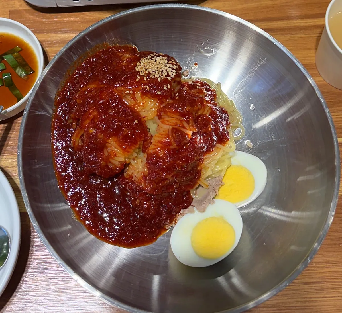 Table spread with water milmyeon, bibim milmyeon, and suyuk