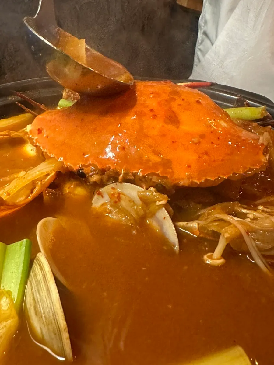 Crab stew bubbling away on the burner