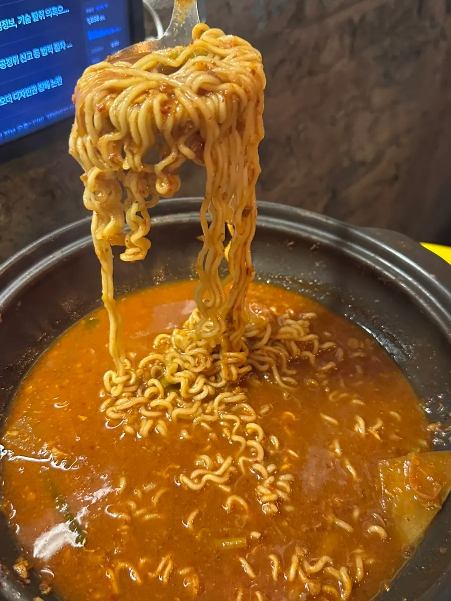 A bowl of crab stew ramyeon with thickened broth
